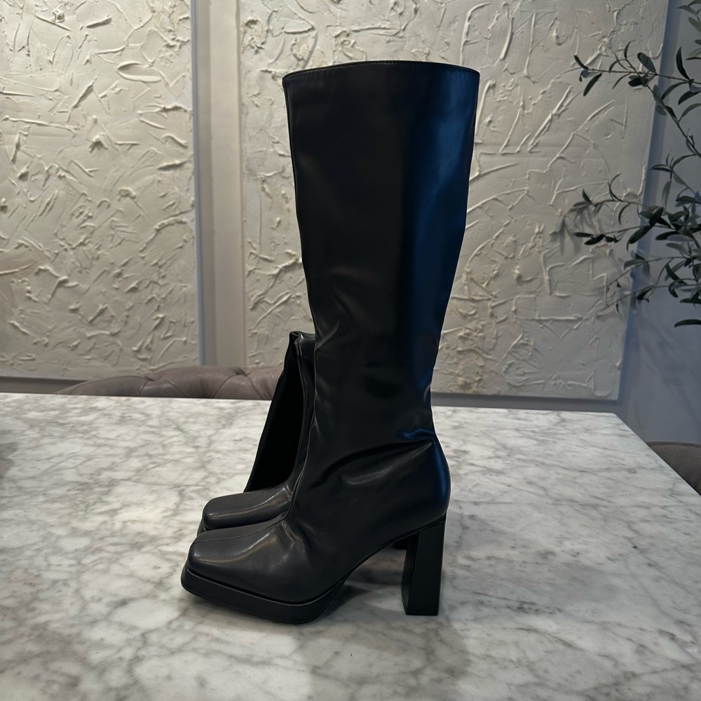 Knee high black boots.